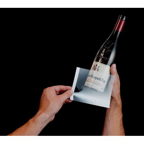 adding a wine label remover to the bottle 