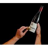 person applying wine label remover to the bottle