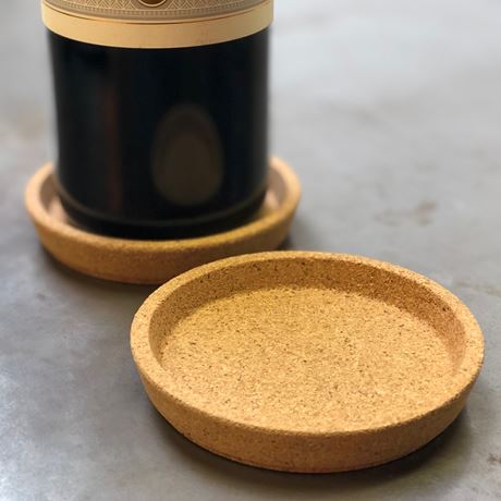 two cork wine coasters with wine bottle