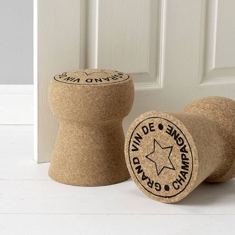 giant champagne cork door stop by a door